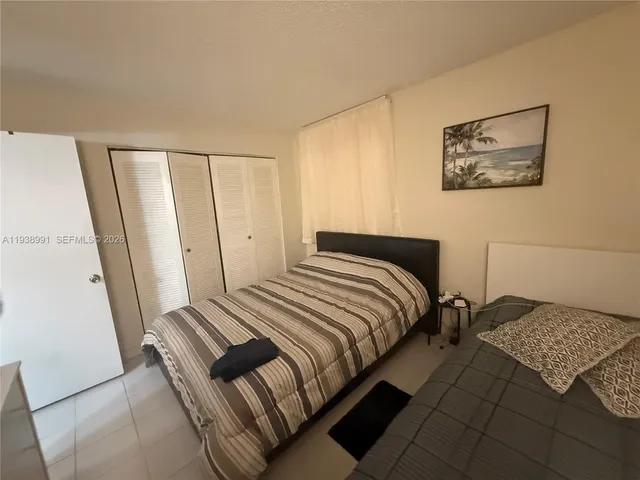 a bedroom with furniture and a window