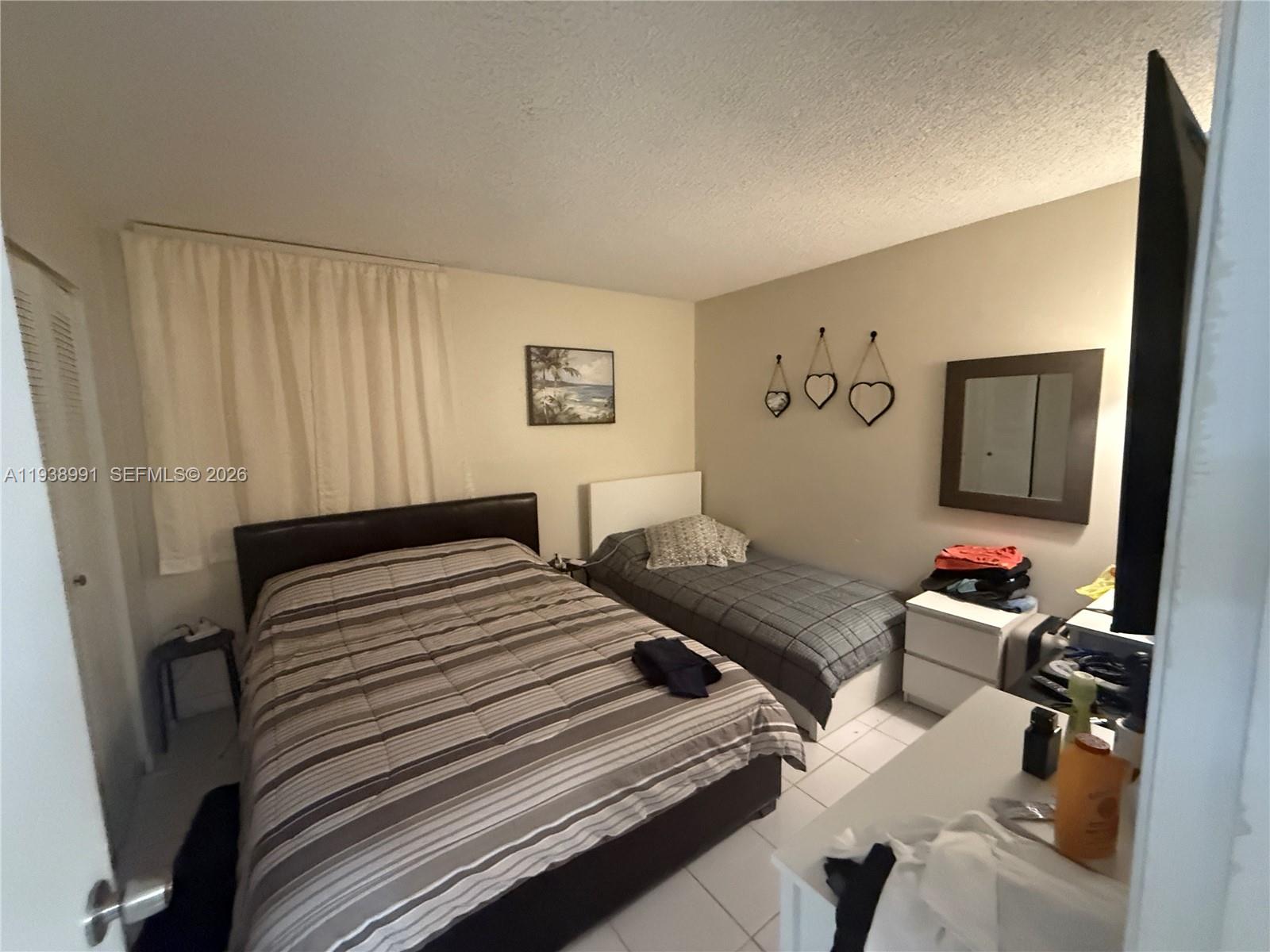 12209 Southwest 14th Lane, Unit 1101 Miami, FL 33184 - Photo 10 of 18 a bedroom with furniture and a window