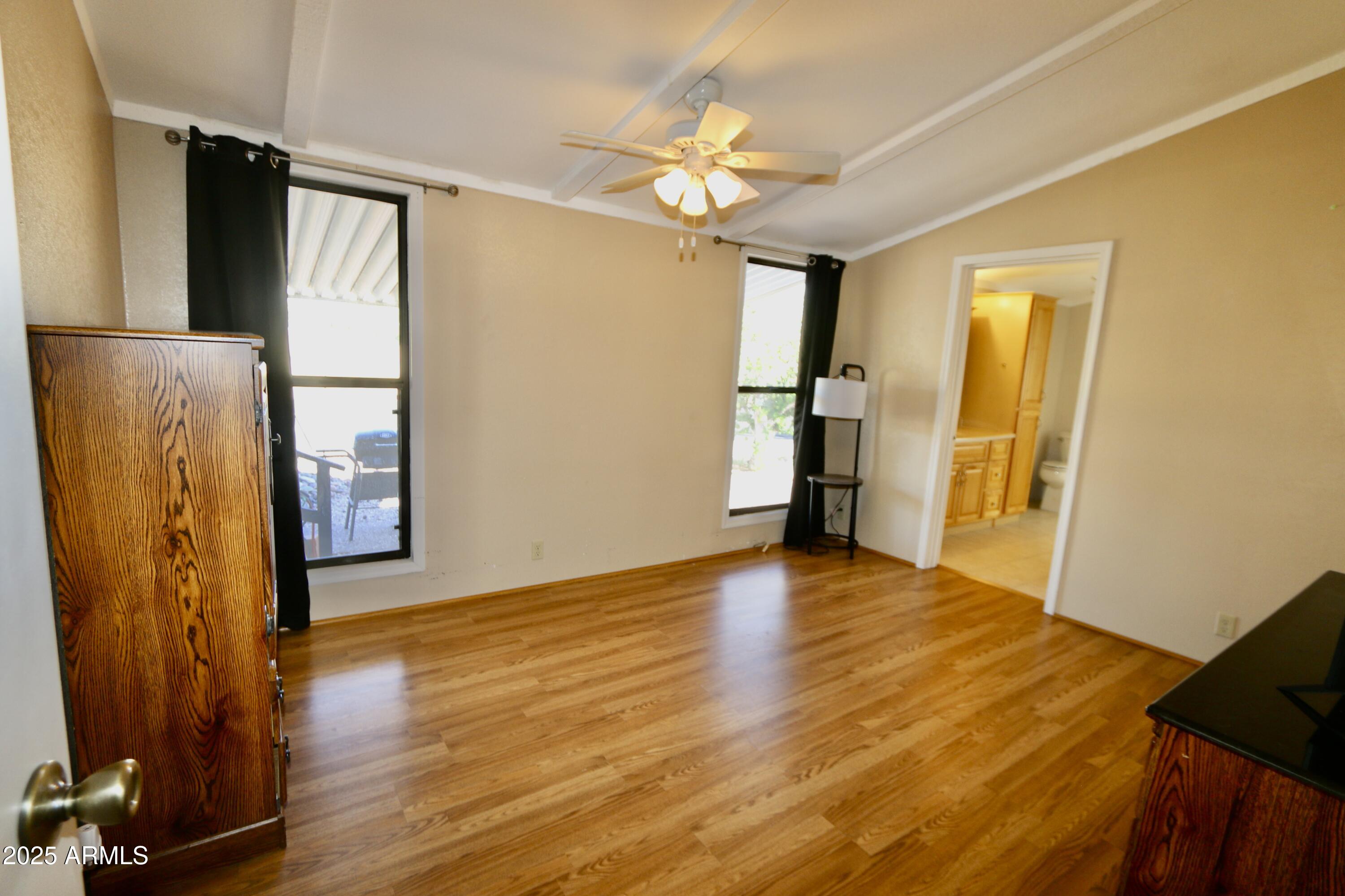 2701 East Utopia Road, Unit 208 Phoenix, AZ 85050 - Photo 12 of 22 a view of a room with wooden floor and a window