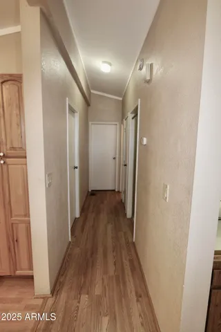 a view of a hallway with wooden floor