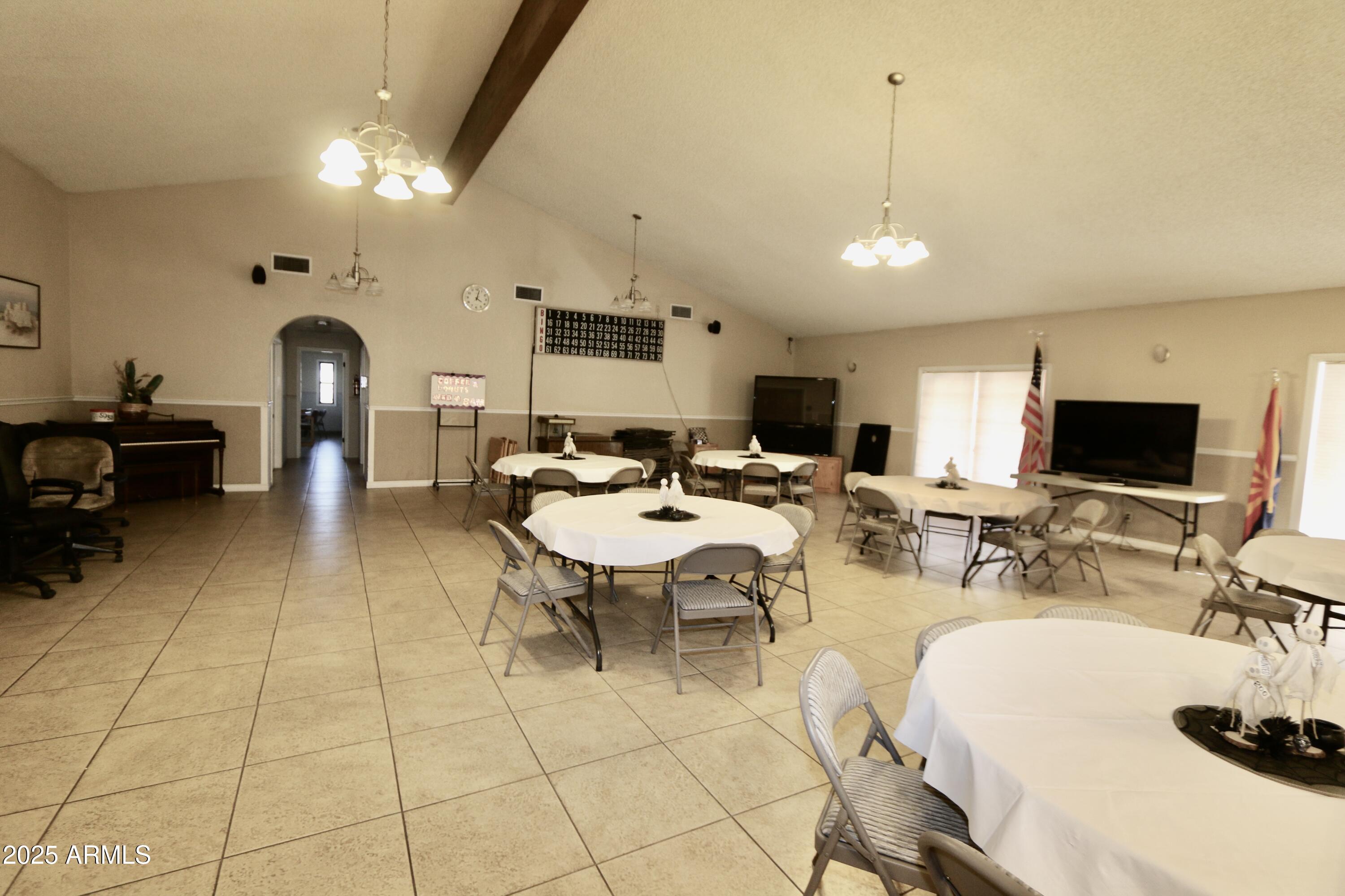 2701 East Utopia Road, Unit 208 Phoenix, AZ 85050 - Photo 17 of 22 a living room with lots of furniture and a flat screen tv