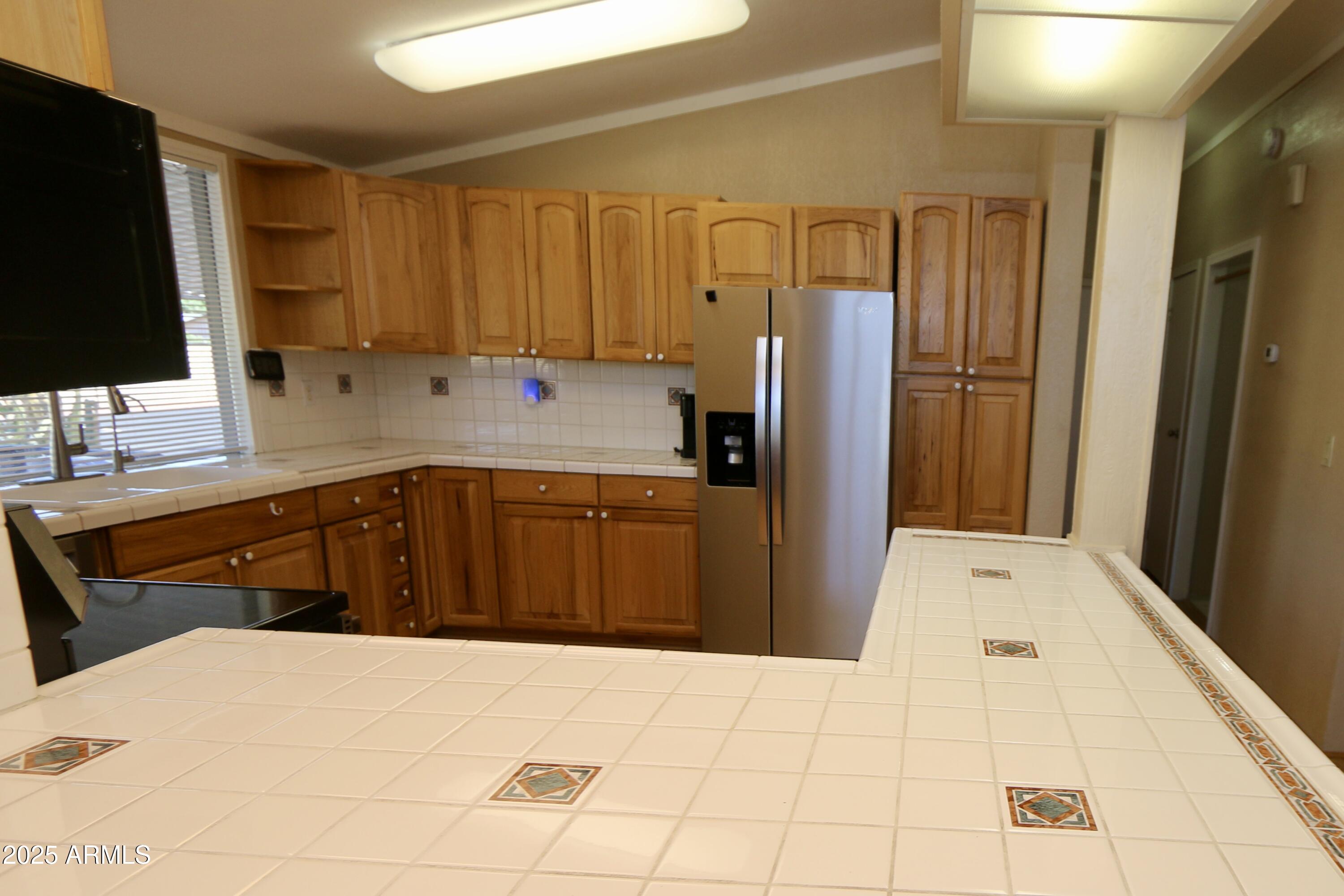 2701 East Utopia Road, Unit 208 Phoenix, AZ 85050 - Photo 3 of 22 a kitchen with a refrigerator sink and cabinets
