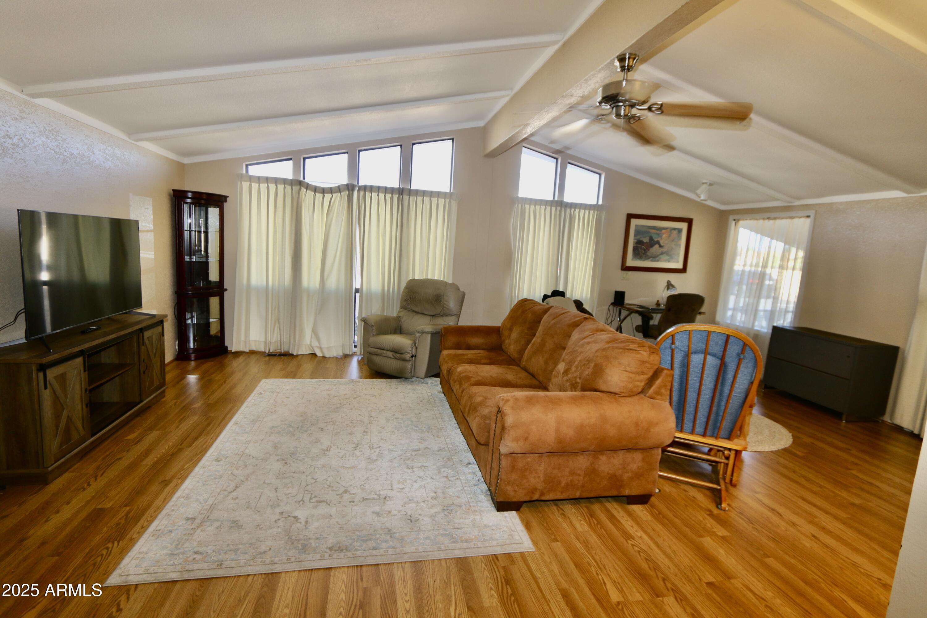 2701 East Utopia Road, Unit 208 Phoenix, AZ 85050 - Photo 4 of 22 a living room with furniture and a flat screen tv