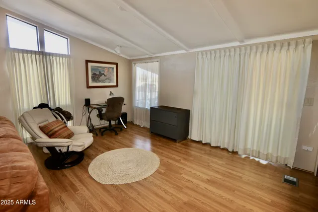 a view of a workspace with furniture and a window