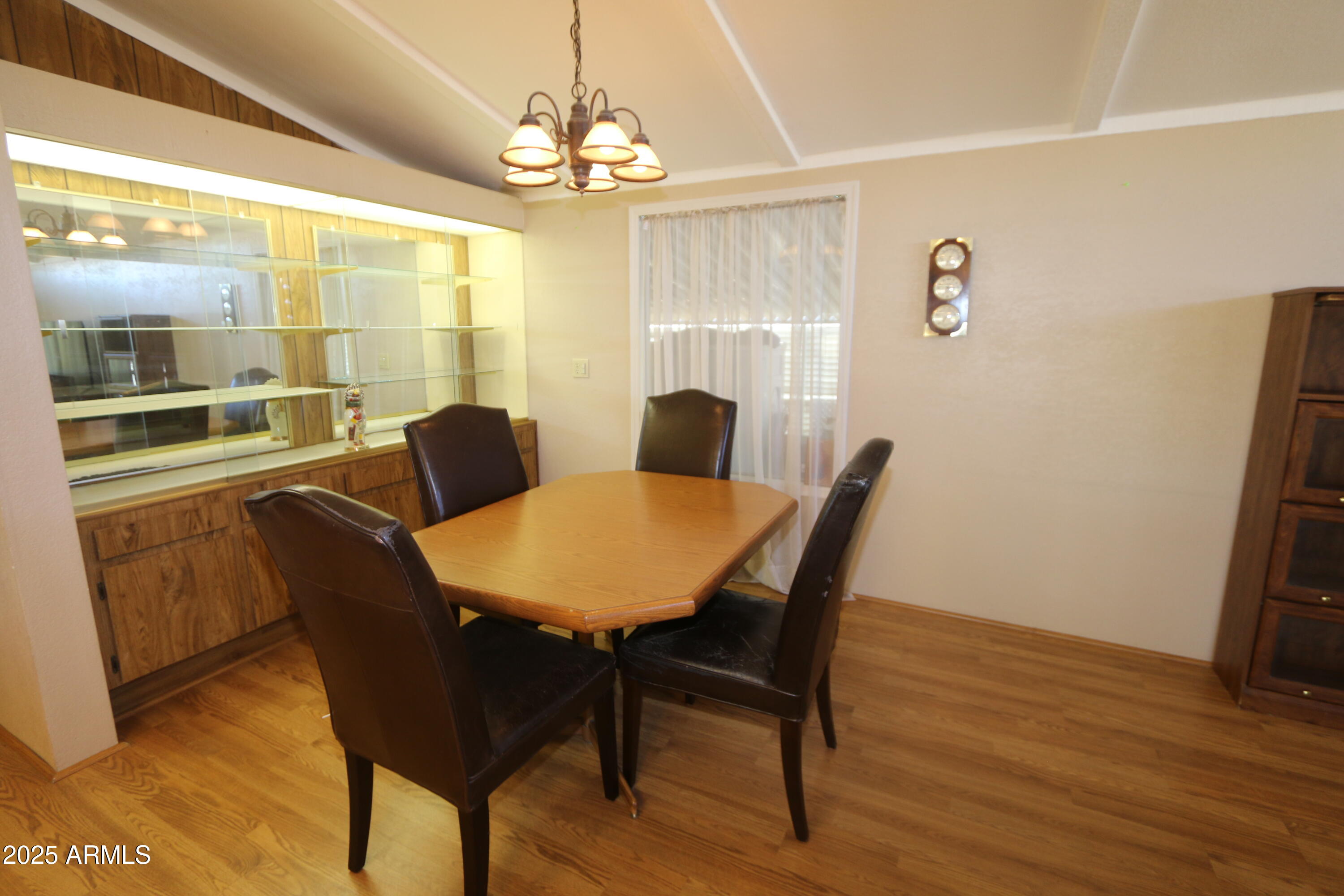 2701 East Utopia Road, Unit 208 Phoenix, AZ 85050 - Photo 7 of 22 a view of a dining room with furniture and wooden floor