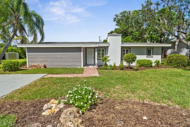 4970 Riverside Drive Estero, FL 33928 - Photo 2 of 35 a front view of house with yard and green space