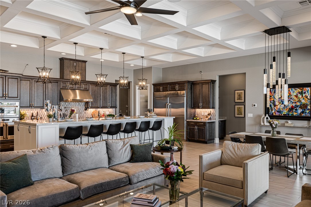10118 Copper Edge Road Las Vegas, NV 89148 - Photo 4 of 48 An open concept living area showcases a coffered ceiling and a gourmet kitchen with a spacious island.