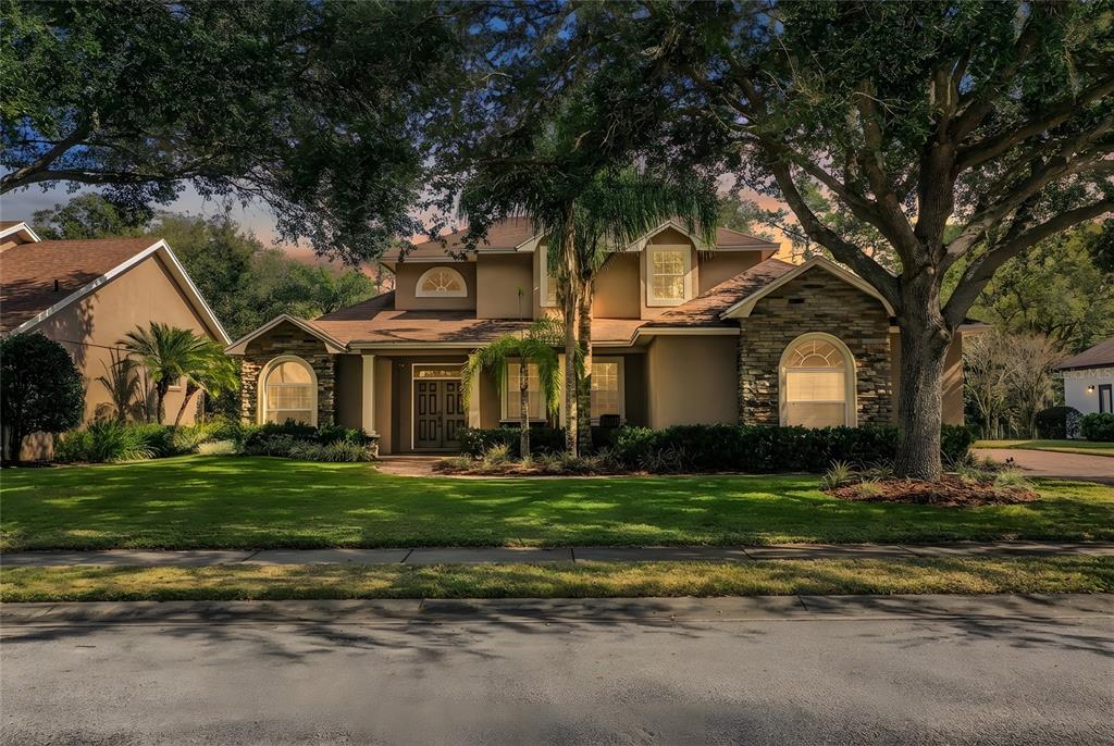 3284 Hawks Ridge Drive Lakeland, FL 33810 - Photo 1 of 1 a front view of a house with a garden