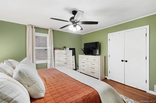 a bedroom with a bed and a ceiling fan