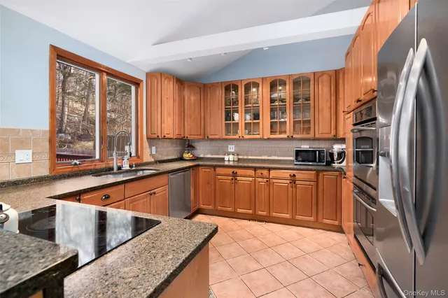 a dining room with furniture a potted plant and wooden floor