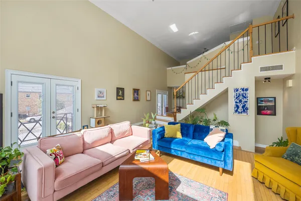 a living room with furniture and a stairs