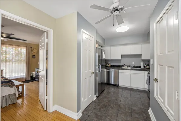 a kitchen with a refrigerator and a stove top oven