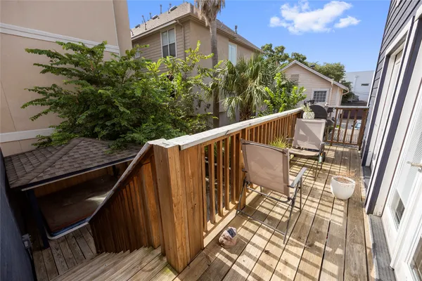 a view of balcony with wooden floor and fence