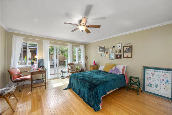 a living room with a bed furniture and a large window