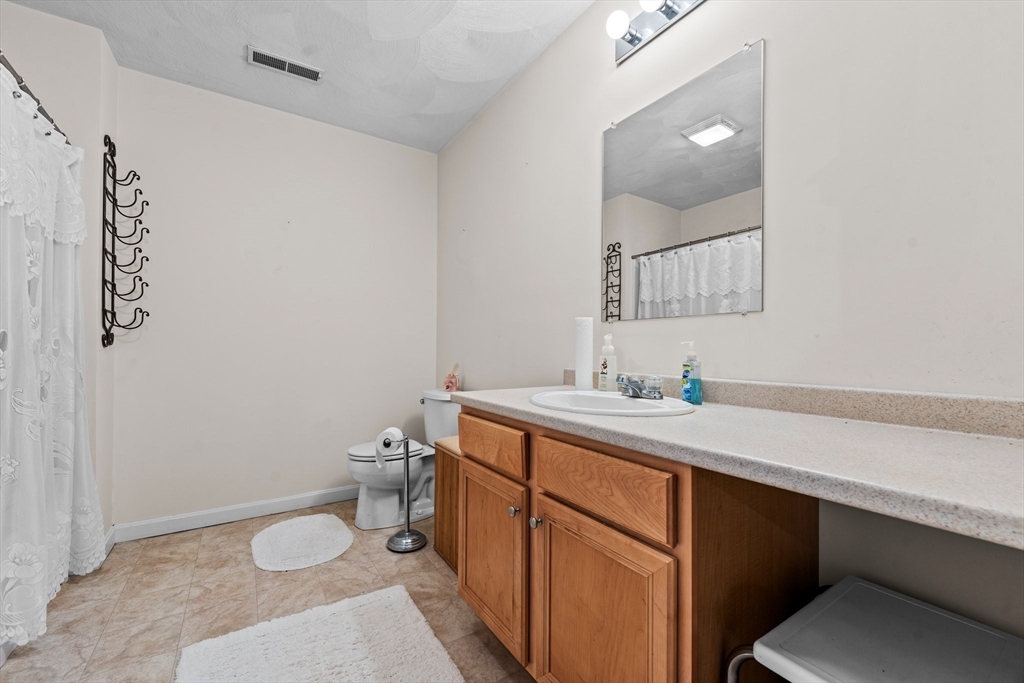 159 Allen Road, Unit 46 Billerica, MA 01821 - Photo 13 of 21 a bathroom with a sink toilet and mirror