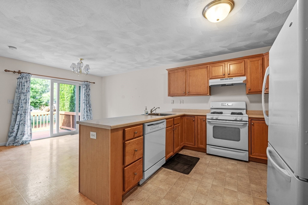 159 Allen Road, Unit 46 Billerica, MA 01821 - Photo 4 of 21 a kitchen with stainless steel appliances granite countertop a stove a sink and a refrigerator