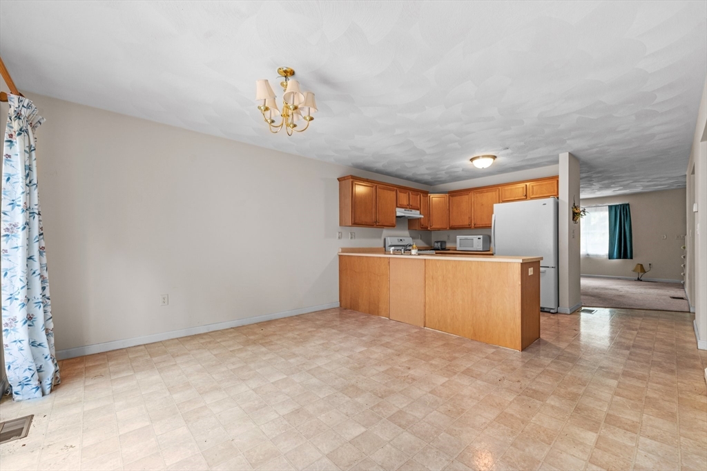 159 Allen Road, Unit 46 Billerica, MA 01821 - Photo 6 of 21 a view of kitchen with kitchen island stainless steel appliances sink stove and refrigerator