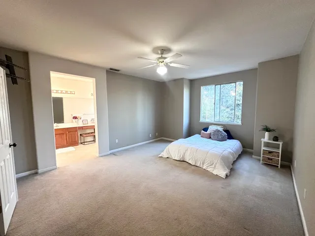 a bed room with a bed and a chandelier