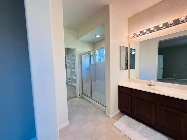 a spacious bathroom with a double vanity sink and mirror
