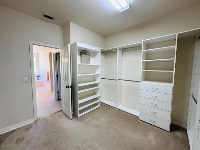 a view of an empty walk in closet