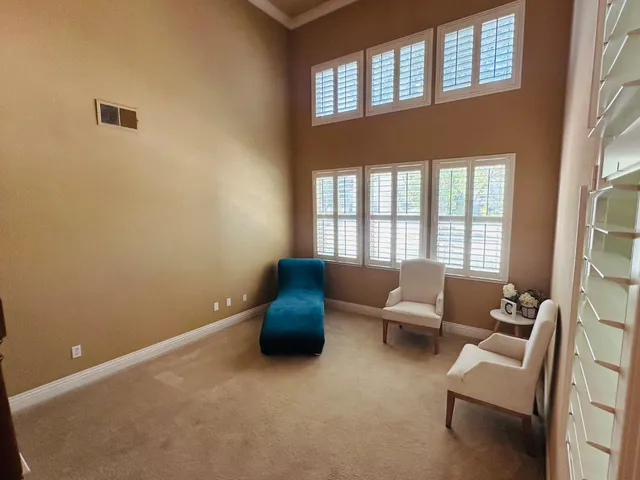 a living room with furniture and a floor to ceiling window