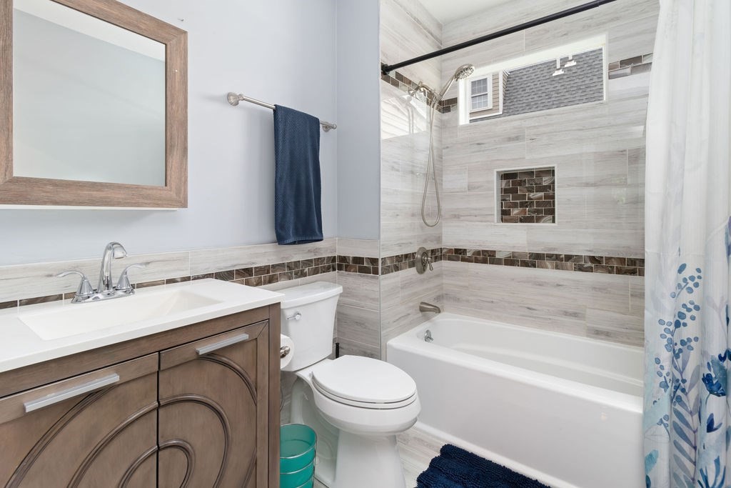 4 Goodwin Court Boston, MA 02127 - Photo 17 of 27 a bathroom with a granite countertop sink mirror vanity and bathtub