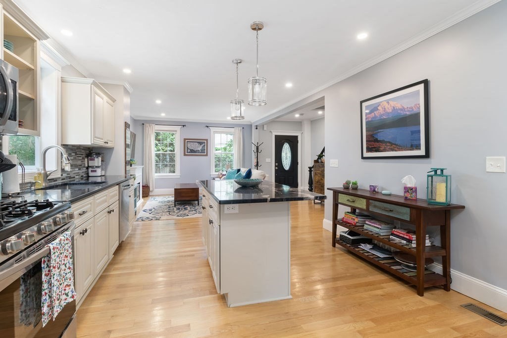 4 Goodwin Court Boston, MA 02127 - Photo 4 of 27 a large kitchen with stainless steel appliances granite countertop a stove and cabinets