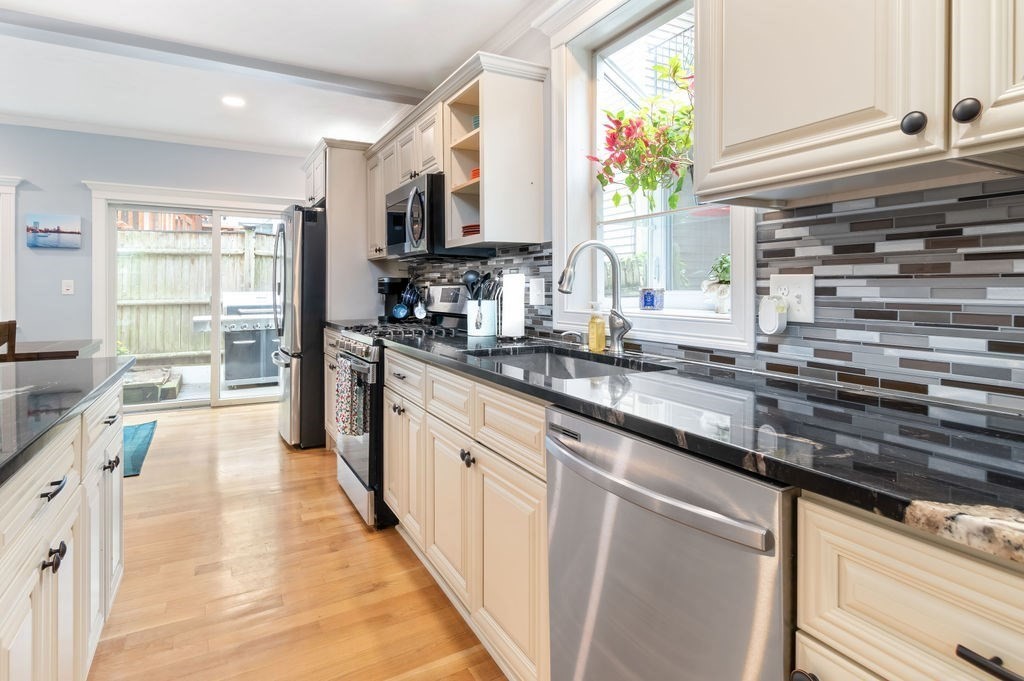 4 Goodwin Court Boston, MA 02127 - Photo 6 of 27 a kitchen with kitchen island granite countertop a sink appliances cabinets and a counter top space