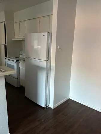 a white refrigerator freezer sitting in a kitchen