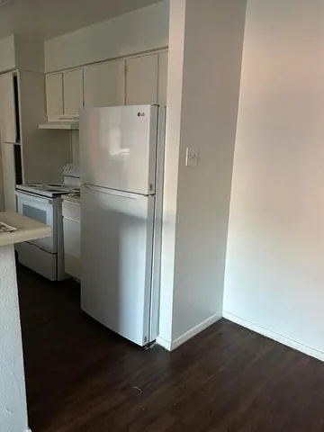 a white refrigerator freezer sitting in a kitchen