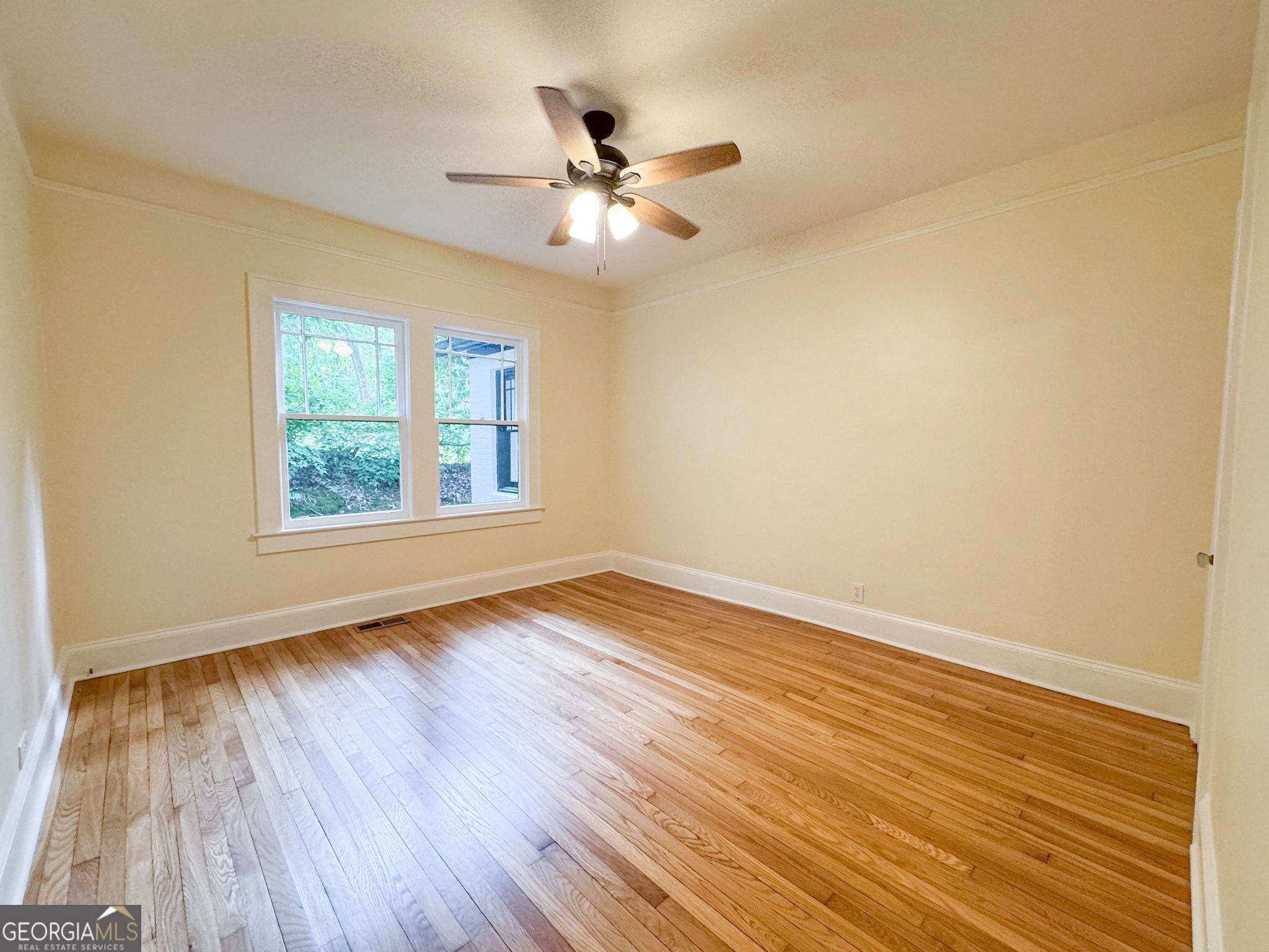 1 Vassar Drive Southeast Rome, GA 30161 - Photo 6 of 12 an empty room with wooden floor chandelier fan and windows