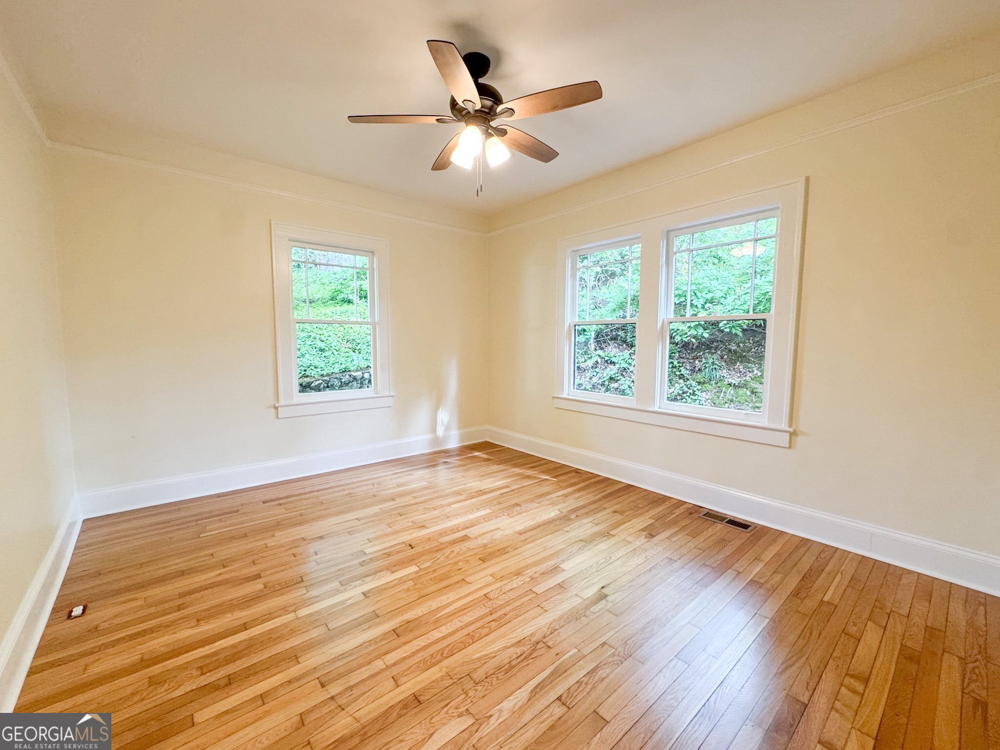 1 Vassar Drive Southeast Rome, GA 30161 - Photo 7 of 12 a view of an empty room with wooden floor and a window