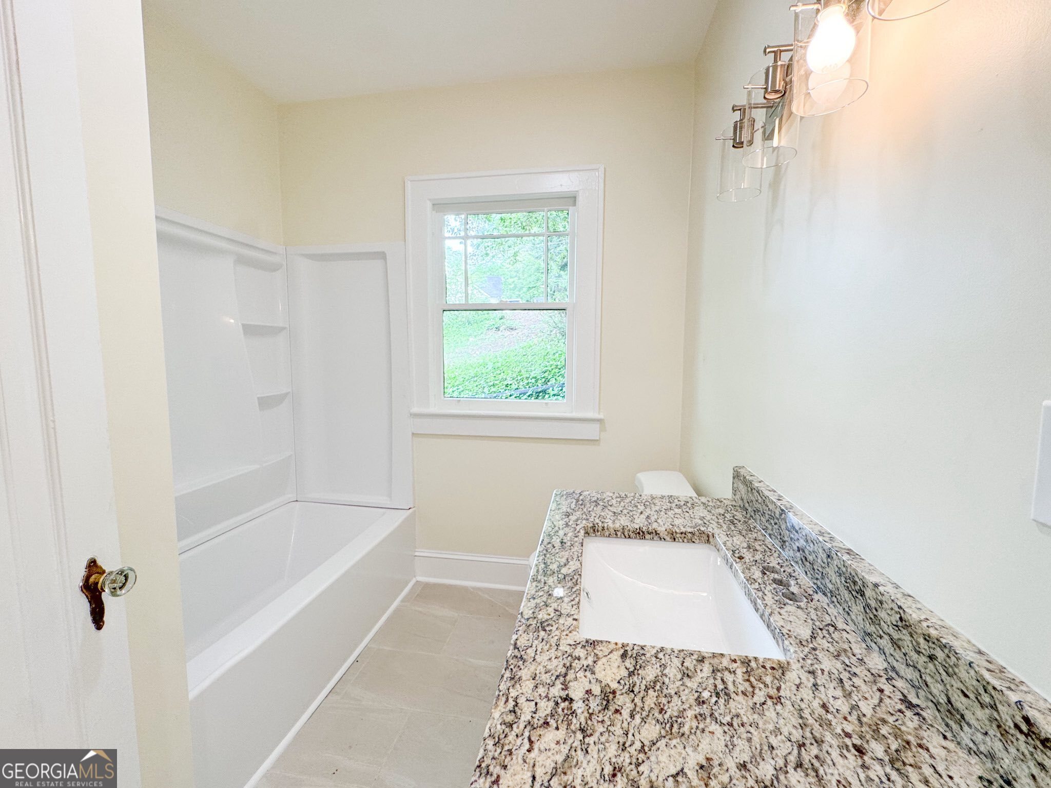 1 Vassar Drive Southeast Rome, GA 30161 - Photo 9 of 12 a bathroom with a granite countertop tub a sink and a window