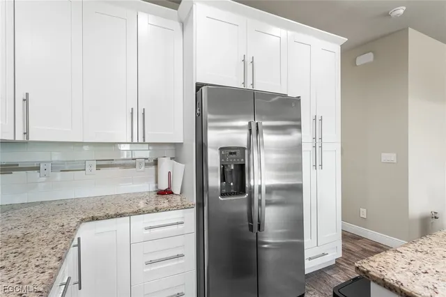 a kitchen with stainless steel appliances granite countertop a refrigerator and a sink