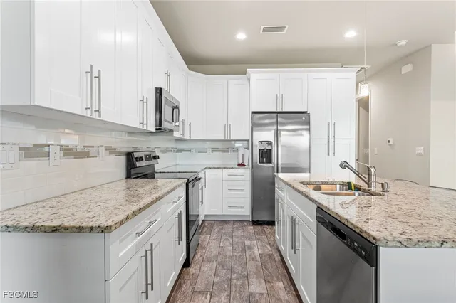 a kitchen with a sink stove and refrigerator