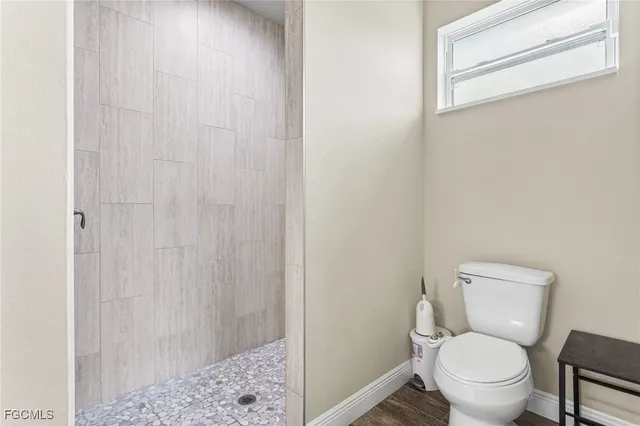 a white toilet sitting next to a shower curtain