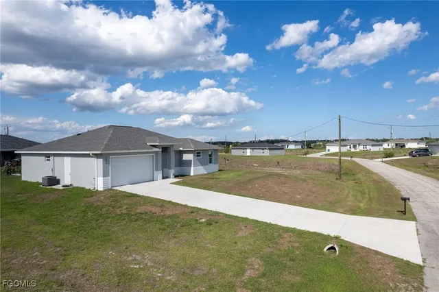 a view of a house with a backyard and a kitchen