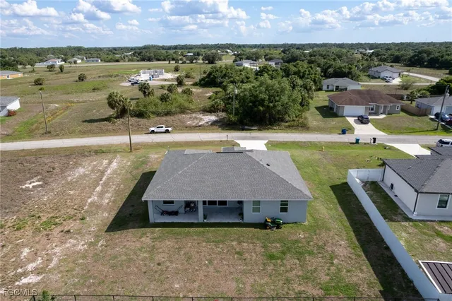 an aerial view of a house with a yard