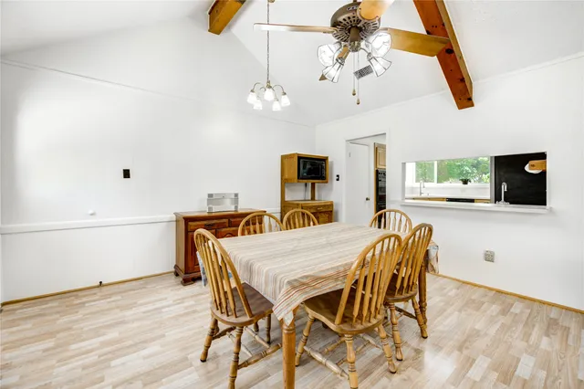 a view of a dining room with furniture and chandelier
