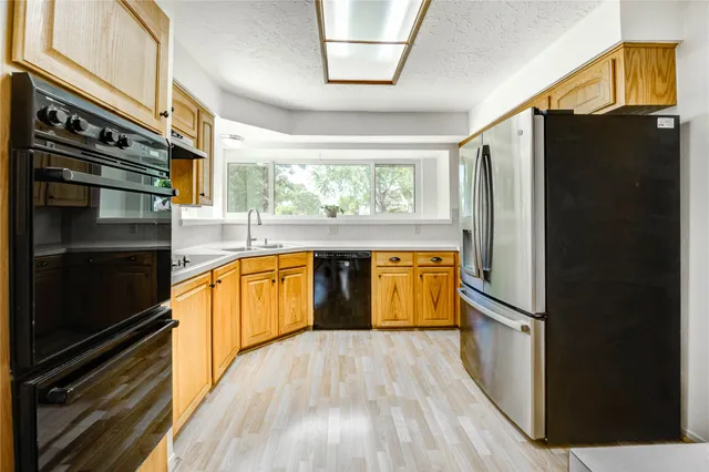 a kitchen with a refrigerator and a stove