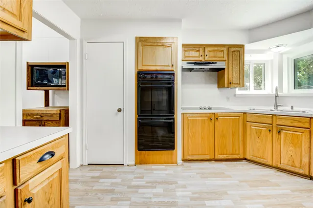a view of a kitchen with a sink dishwasher and a refrigerator