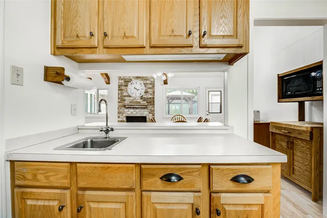 a kitchen with stainless steel appliances granite countertop a sink and a stove
