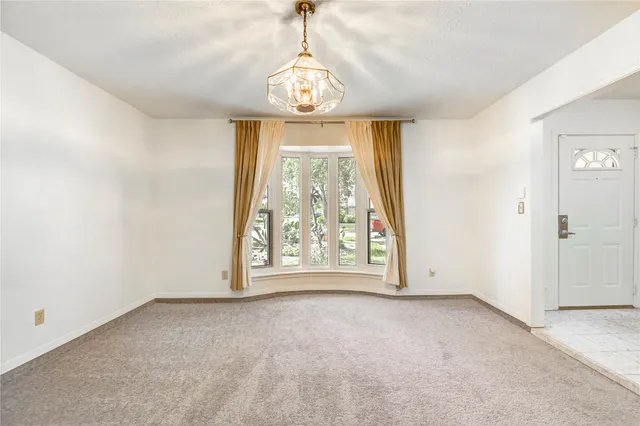 an empty room with windows and outdoor view