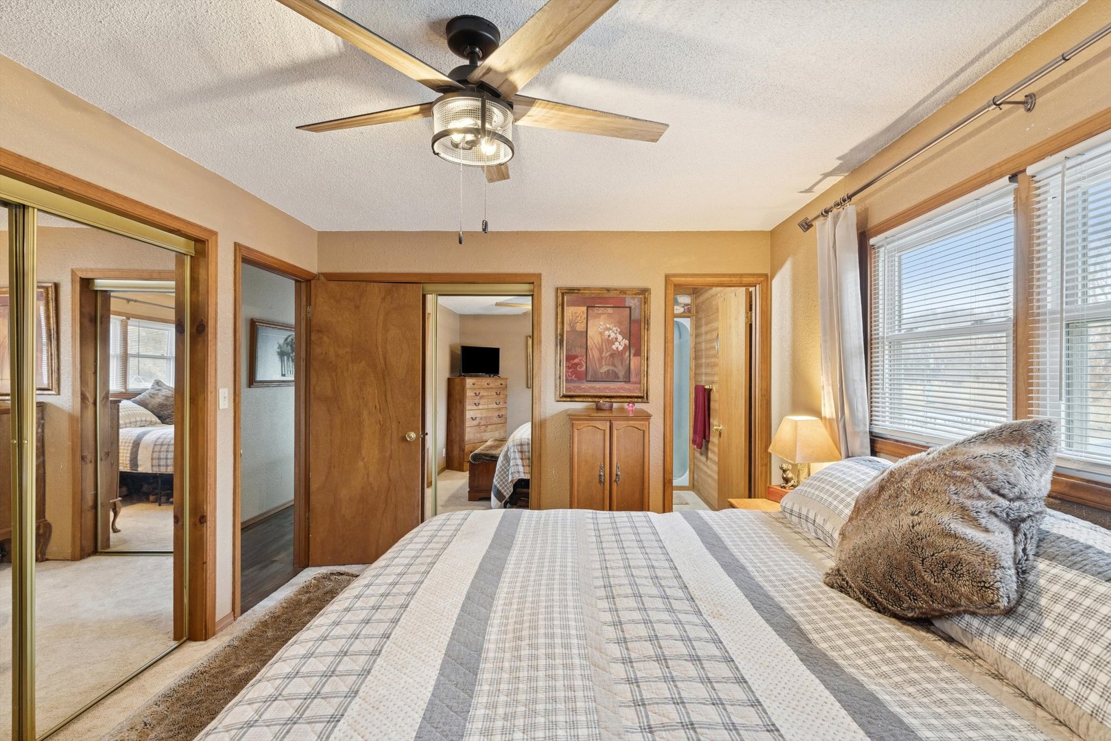 5430 Holly Road Fulton, IL 61252 - Photo 15 of 33 a bedroom with a large bed and a chandelier