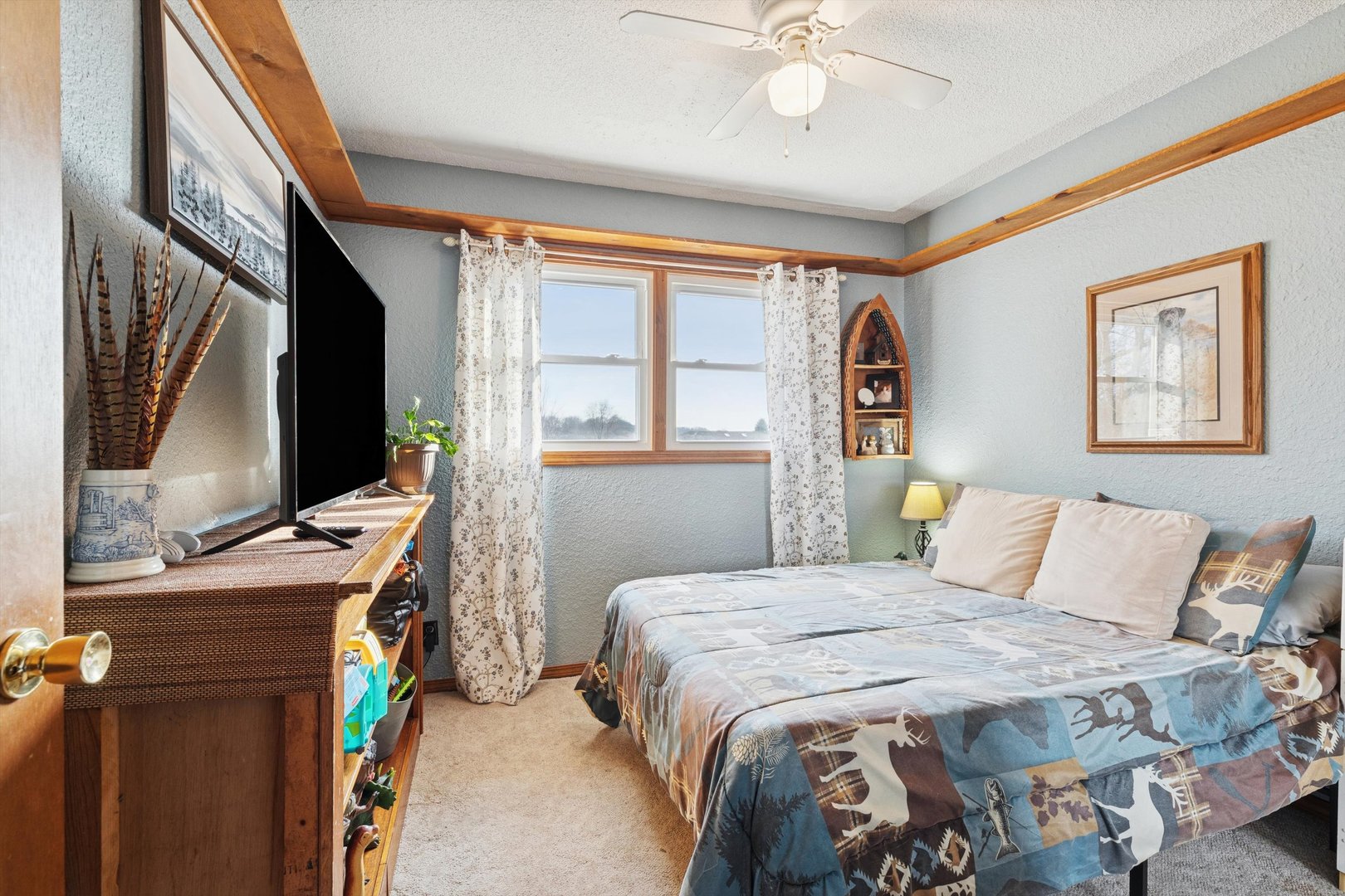 5430 Holly Road Fulton, IL 61252 - Photo 18 of 33 a bedroom with a bed dresser and flat screen tv