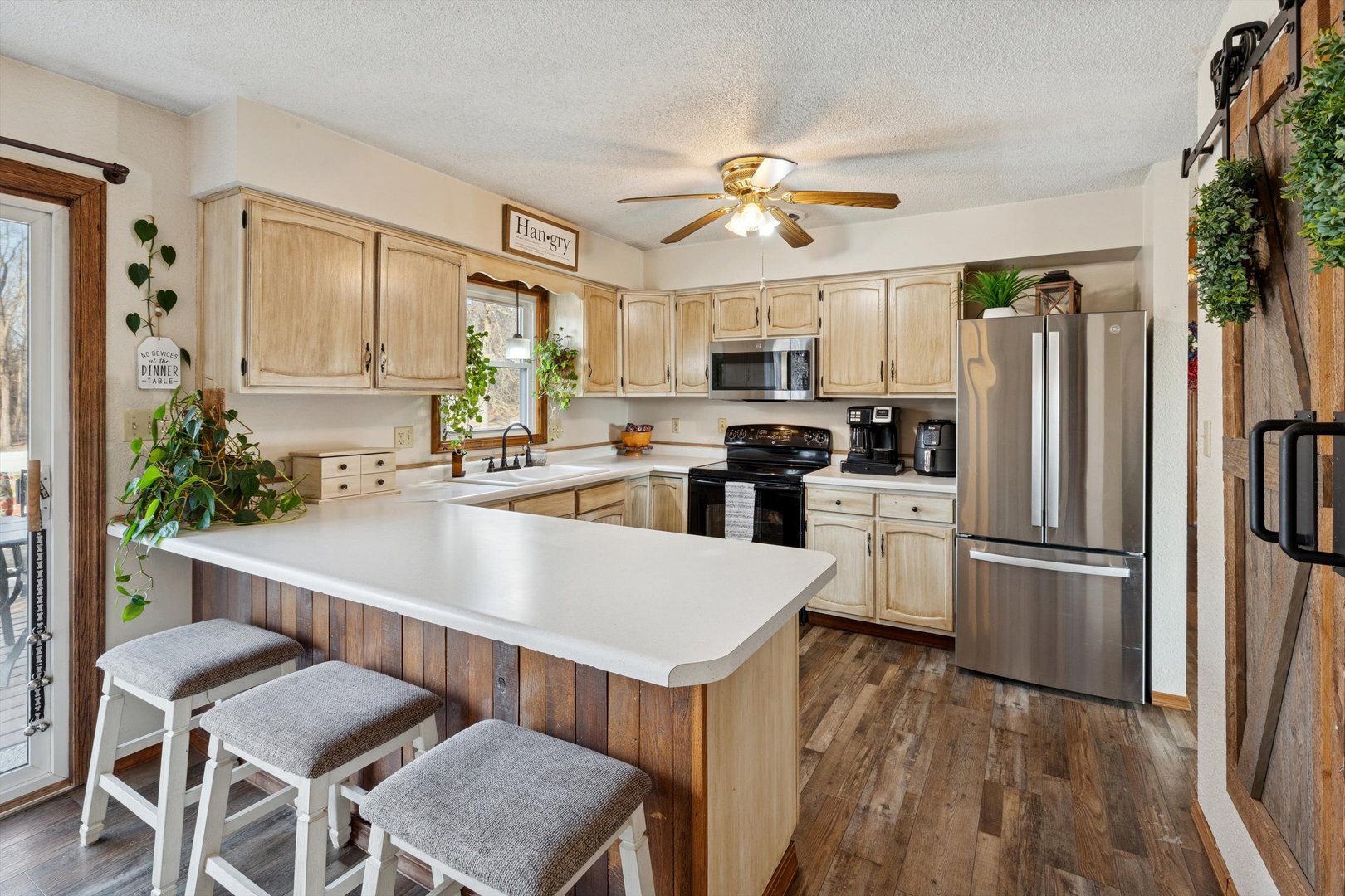 5430 Holly Road Fulton, IL 61252 - Photo 8 of 33 a kitchen with refrigerator cabinets and wooden floor