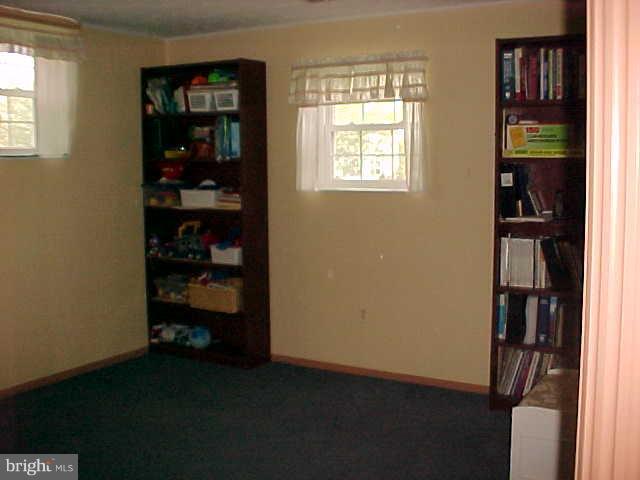 1909 Bayberry Road Edgewood, MD 21040 - Photo 12 of 28 an empty room with bookshelf and wooden floor