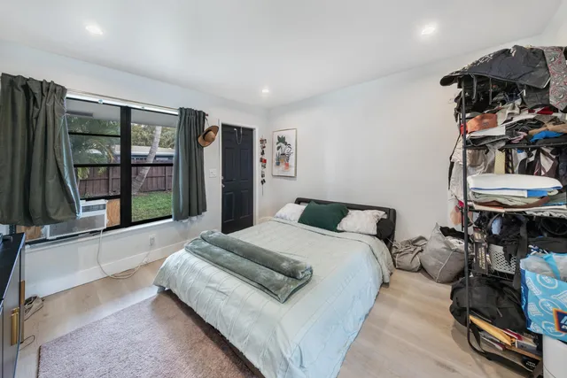 a spacious bedroom with a bed and a large window