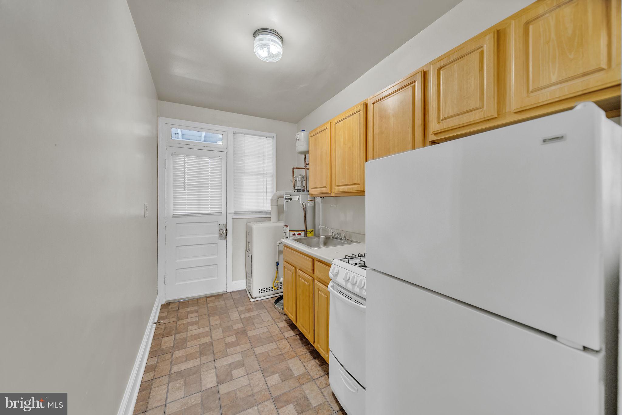 220 21st Street Northeast Washington, DC 20002 - Photo 16 of 26 a kitchen with a refrigerator a stove top oven and cabinets