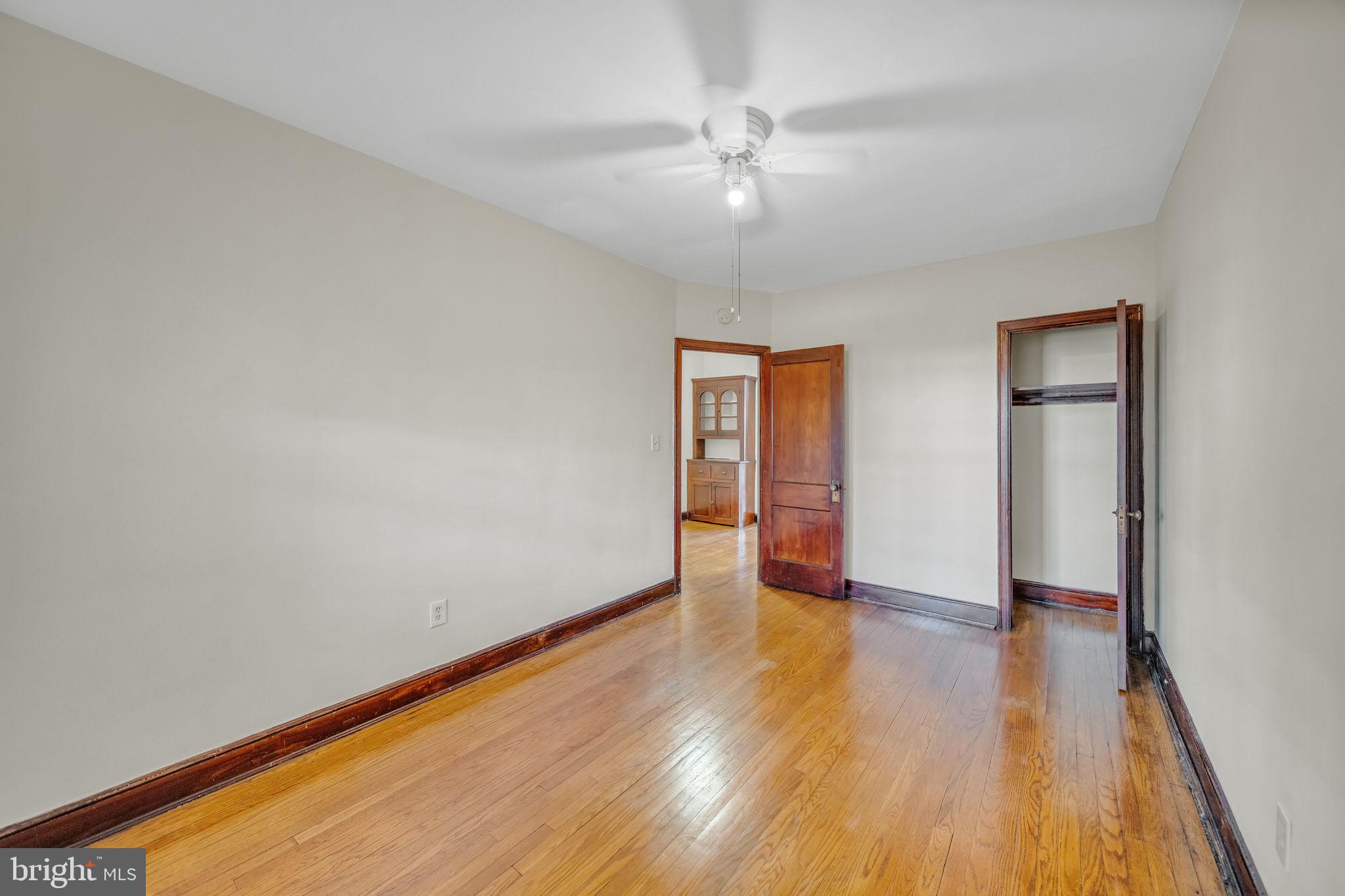 220 21st Street Northeast Washington, DC 20002 - Photo 19 of 26 an empty room with wooden floor chandelier fan and windows